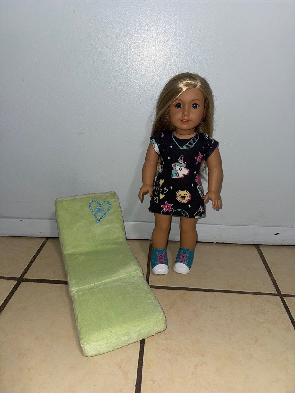 American Girl Blonde Doll with green comfort chair